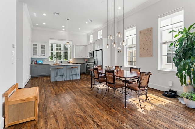5658 Darling St, Houston, TX 77007 - dining area with crown molding, healthy amount of natural light, dark wood-type flooring, a towering ceiling, and recessed lighting