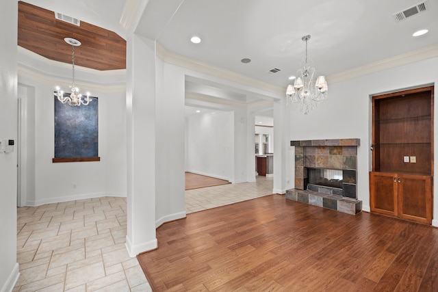 3118 Rosemary Park Ln, Houston, TX 77082 - unfurnished living room featuring a chandelier, ornamental molding, a fireplace, and wood finished floors