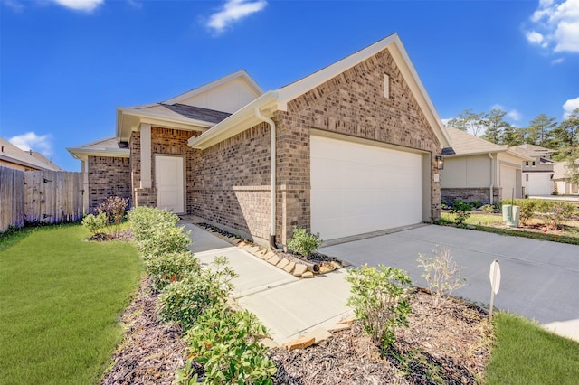 32014 Quail Terrace Ln, Conroe, TX 77385 - view of front of house featuring brick siding, a garage, and driveway