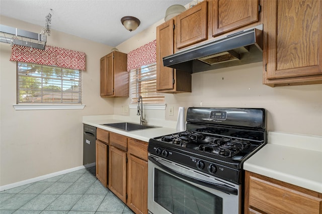 2721 Overland Trl, Dickinson, TX 77539 - kitchen with range with gas stovetop, under cabinet range hood, black dishwasher, light countertops, and brown cabinetry