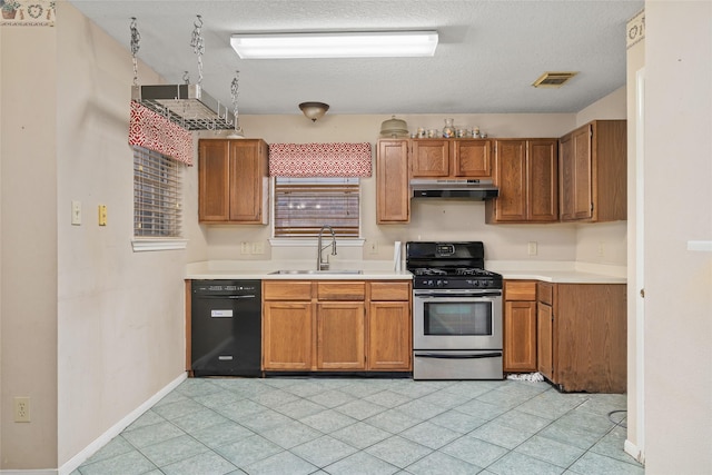 2721 Overland Trl, Dickinson, TX 77539 - kitchen featuring stainless steel gas range, dishwasher, under cabinet range hood, light countertops, and brown cabinets