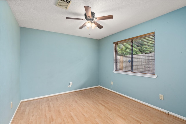 2721 Overland Trl, Dickinson, TX 77539 - unfurnished room with wood finished floors, a ceiling fan, and a textured ceiling