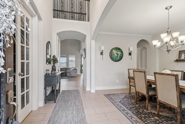 15521 Atwood Bay Trl, Cypress, TX 77433 - dining room featuring arched walkways, a chandelier, and crown molding