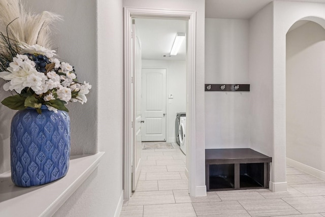 15521 Atwood Bay Trl, Cypress, TX 77433 - hallway featuring separate washer and dryer and arched walkways
