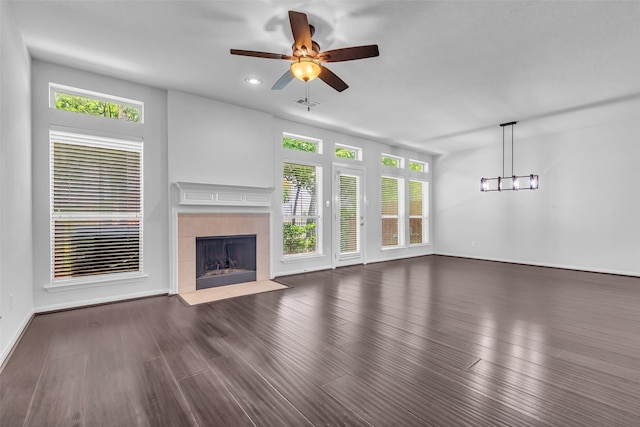 2223 Ridge Wood Ln, Sugar Land, TX 77479 - unfurnished living room with healthy amount of natural light, a tile fireplace, ceiling fan, wood finished floors, and recessed lighting