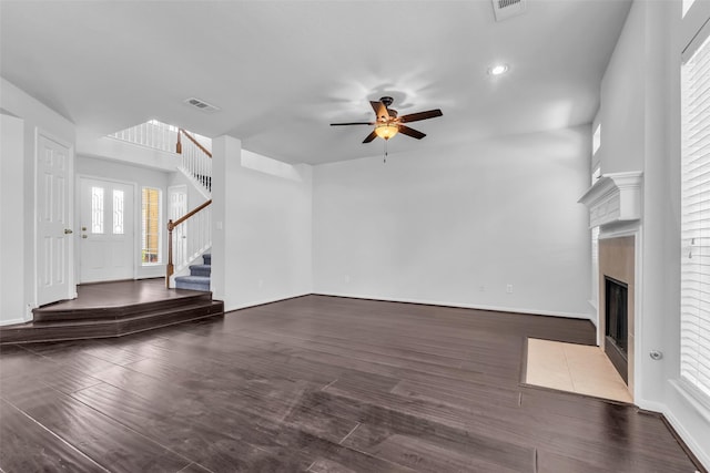 2223 Ridge Wood Ln, Sugar Land, TX 77479 - unfurnished living room with a ceiling fan, stairs, wood finished floors, a fireplace with flush hearth, and recessed lighting