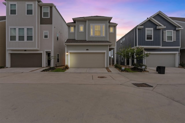 3207 Cedar Dawn Ln, Houston, TX 77091 - view of front of house featuring an attached garage, concrete driveway, and board and batten siding