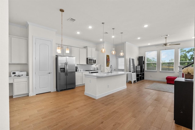 3207 Cedar Dawn Ln, Houston, TX 77091 - kitchen featuring stainless steel appliances, open floor plan, light countertops, white cabinets, and ornamental molding