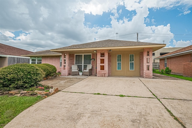 1931 Ansbury Dr, Houston, TX 77018 - view of front of home featuring brick siding, a porch, and a shingled roof