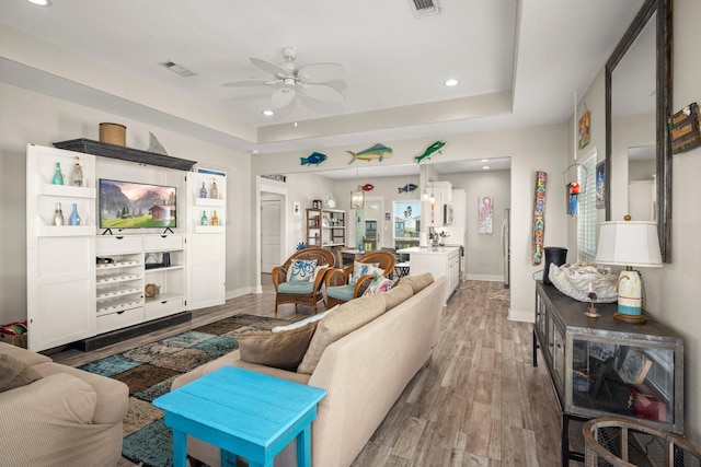 3292 Hidden Gold Prt, Bolivar, TX 77650 - living room with a ceiling fan, light wood-type flooring, recessed lighting, and a raised ceiling
