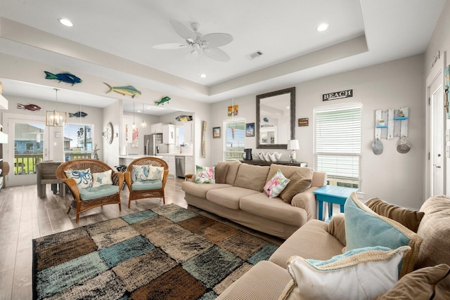 3292 Hidden Gold Prt, Bolivar, TX 77650 - living room with ceiling fan, light wood finished floors, a tray ceiling, recessed lighting, and beverage cooler