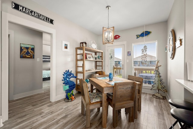 3292 Hidden Gold Prt, Bolivar, TX 77650 - dining space featuring light wood-style floors and a chandelier