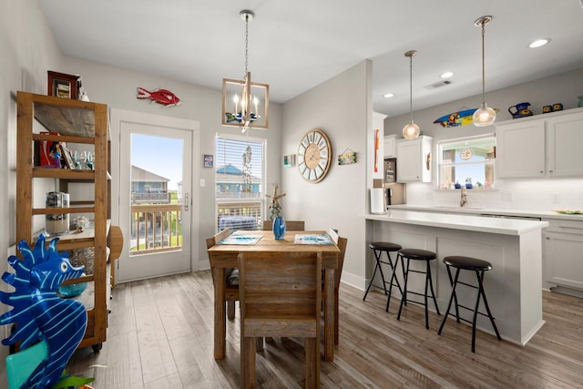 3292 Hidden Gold Prt, Bolivar, TX 77650 - dining space featuring healthy amount of natural light, wood finished floors, a chandelier, and recessed lighting