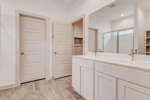 3026 Stock Orchard Ln, Houston, TX 77047 - full bath featuring a stall shower, a walk in closet, wood finished floors, double vanity, and recessed lighting