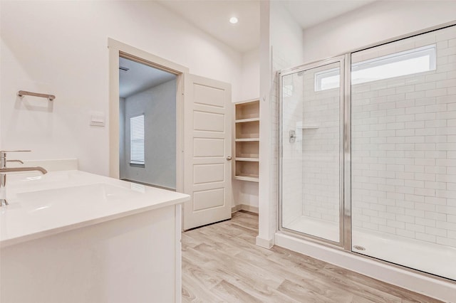 3026 Stock Orchard Ln, Houston, TX 77047 - bathroom with a shower stall, wood finished floors, vanity, and recessed lighting