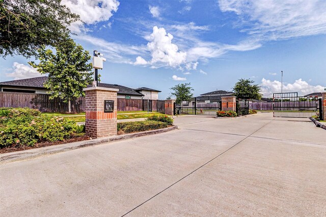 3026 Stock Orchard Ln, Houston, TX 77047 - view of concrete road featuring a gate, a gated entry, and curbs