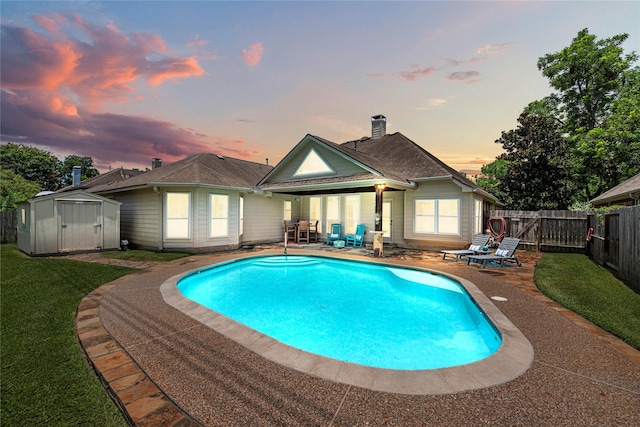 9618 Roarks Psge, Missouri City, TX 77459 - pool at dusk with a patio, a fenced backyard, and a shed