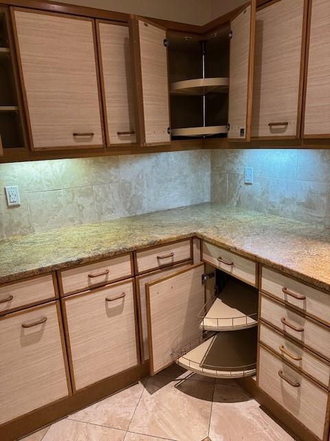40 N Interstate 35 Unit 3D3, Austin, TX 78701 - kitchen featuring open shelves, tasteful backsplash, and light tile patterned floors