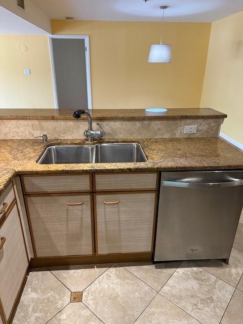 40 N Interstate 35 Unit 3D3, Austin, TX 78701 - kitchen with dishwasher, dark stone counters, and light tile patterned floors