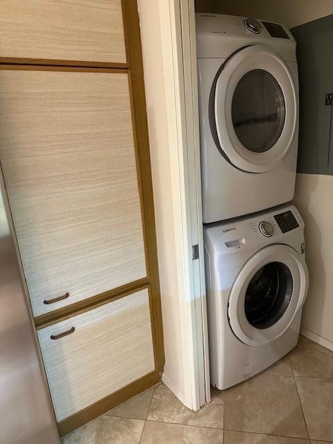 40 N Interstate 35 Unit 3D3, Austin, TX 78701 - laundry room with stacked washer / dryer and light tile patterned floors