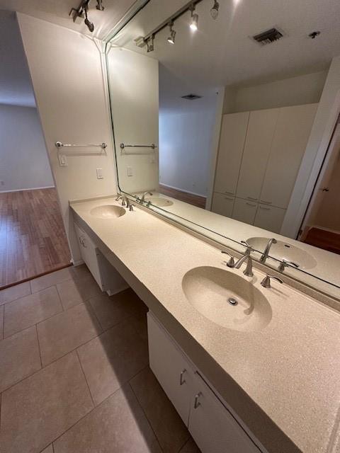 40 N Interstate 35 Unit 3D3, Austin, TX 78701 - bathroom with rail lighting, double vanity, and tile patterned floors