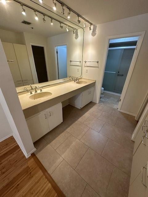 40 N Interstate 35 Unit 3D3, Austin, TX 78701 - full bathroom featuring double vanity, a closet, and rail lighting
