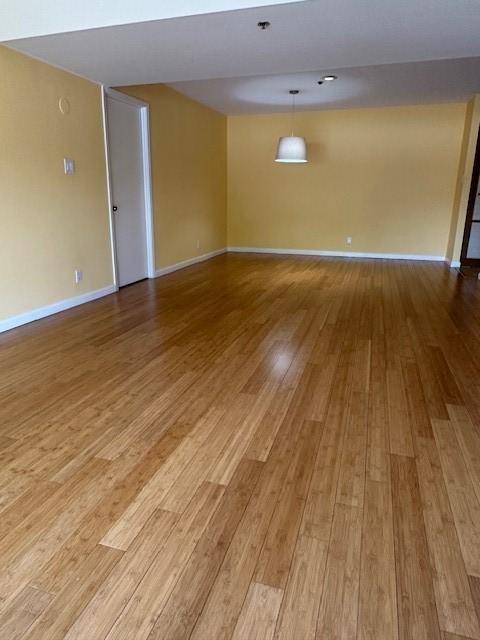 40 N Interstate 35 Unit 3D3, Austin, TX 78701 - empty room featuring wood finished floors and baseboards