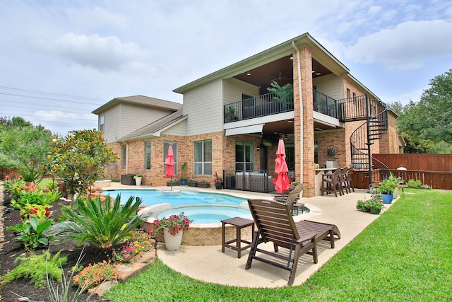 9303 Georgetown Glen Cir, Cypress, TX 77433 - back of house featuring a balcony, ceiling fan, brick siding, a patio area, and stairway
