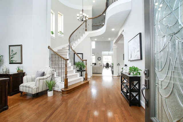 9303 Georgetown Glen Cir, Cypress, TX 77433 - foyer with a towering ceiling, stairway, hardwood / wood-style floors, and a chandelier