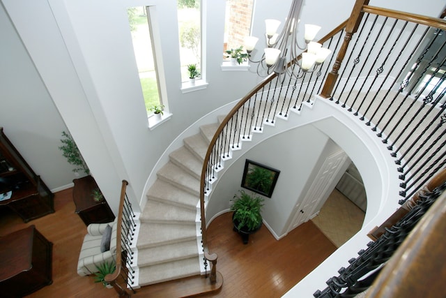 9303 Georgetown Glen Cir, Cypress, TX 77433 - stairs with wood finished floors, a towering ceiling, and a chandelier