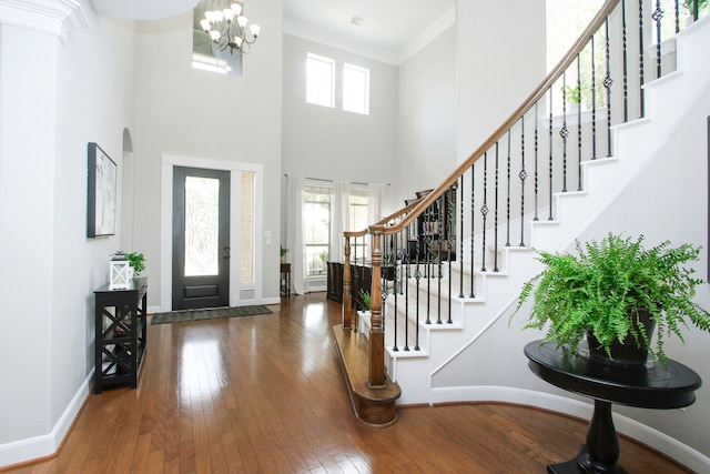 9303 Georgetown Glen Cir, Cypress, TX 77433 - foyer with wood-type flooring, stairway, a chandelier, crown molding, and a towering ceiling