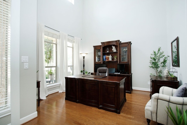 9303 Georgetown Glen Cir, Cypress, TX 77433 - office area featuring a towering ceiling and light wood-style flooring