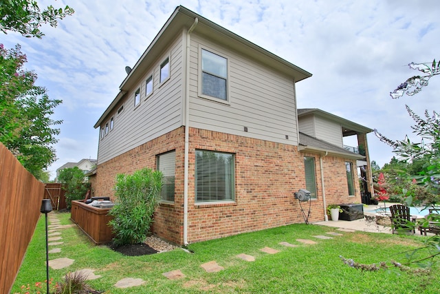 9303 Georgetown Glen Cir, Cypress, TX 77433 - back of property featuring brick siding, a patio, and a fenced backyard
