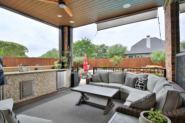9303 Georgetown Glen Cir, Cypress, TX 77433 - fenced backyard with outdoor lounge area, an outdoor kitchen, a ceiling fan, and a patio area
