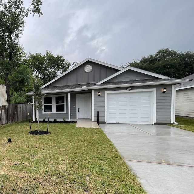 7916 Tate St, Houston, TX 77028 - ranch-style home with driveway, board and batten siding, and an attached garage
