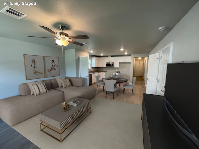 7916 Tate St, Houston, TX 77028 - living area with light wood finished floors, ceiling fan, and recessed lighting