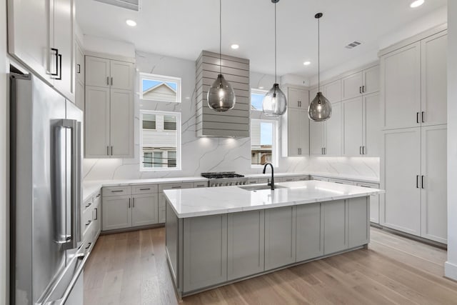 4705 Gibson St, Houston, TX 77007 - kitchen with stainless steel appliances, healthy amount of natural light, light wood finished floors, an island with sink, and recessed lighting