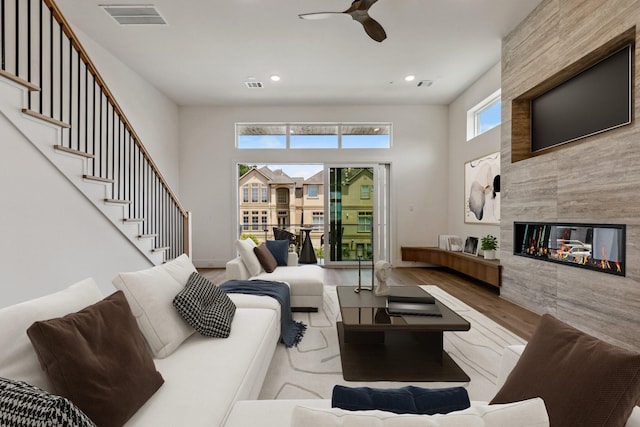 4705 Gibson St, Houston, TX 77007 - living area featuring wood finished floors, ceiling fan, recessed lighting, a fireplace, and stairway
