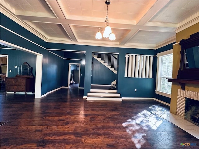 1002 E Gonzales St, Yoakum, TX 77995 - unfurnished living room with a chandelier, coffered ceiling, stairway, wood finished floors, and crown molding