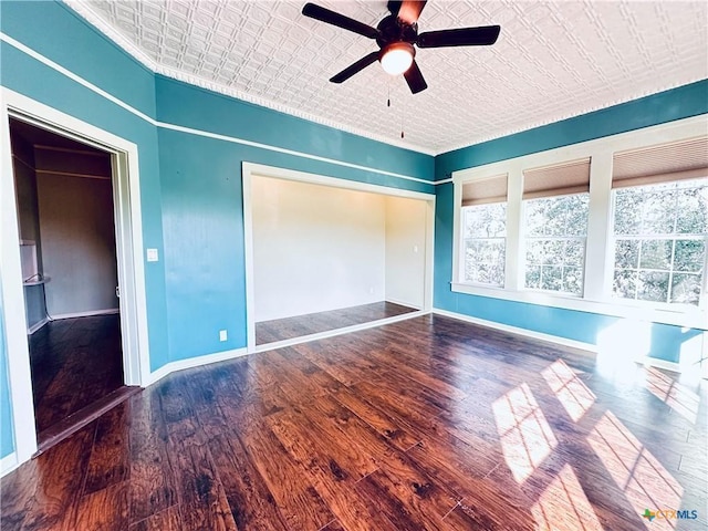 1002 E Gonzales St, Yoakum, TX 77995 - unfurnished bedroom featuring an ornate ceiling, wood finished floors, a ceiling fan, a closet, and crown molding