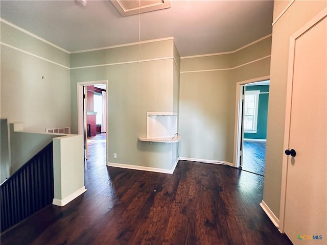 1002 E Gonzales St, Yoakum, TX 77995 - empty room with wood finished floors, attic access, and crown molding