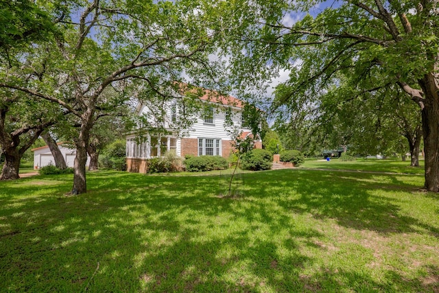 1002 E Gonzales St, Yoakum, TX 77995 - view of green lawn with a garage
