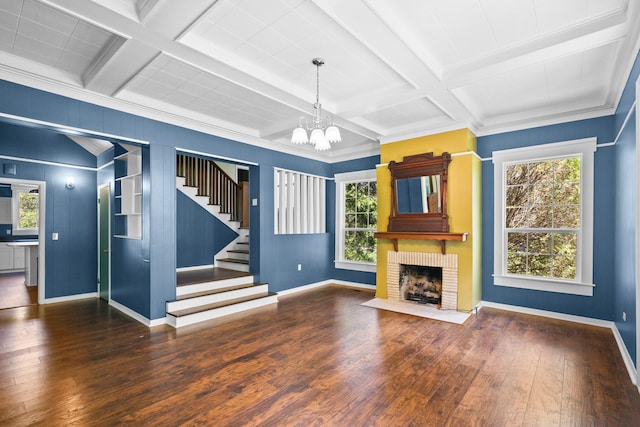 1002 E Gonzales St, Yoakum, TX 77995 - unfurnished living room with a chandelier, hardwood / wood-style floors, stairway, coffered ceiling, and a fireplace