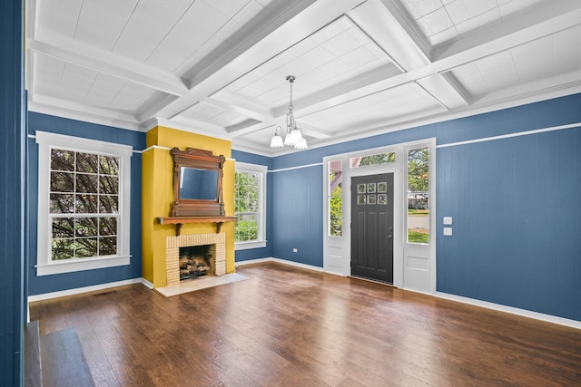 1002 E Gonzales St, Yoakum, TX 77995 - unfurnished living room with hardwood / wood-style flooring, a chandelier, beam ceiling, coffered ceiling, and a fireplace