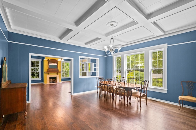 1002 E Gonzales St, Yoakum, TX 77995 - dining space with a chandelier, hardwood / wood-style floors, beam ceiling, a fireplace with flush hearth, and coffered ceiling