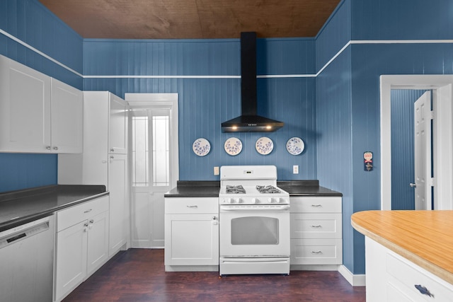 1002 E Gonzales St, Yoakum, TX 77995 - kitchen featuring gas range gas stove, dishwasher, wall chimney exhaust hood, and dark wood finished floors