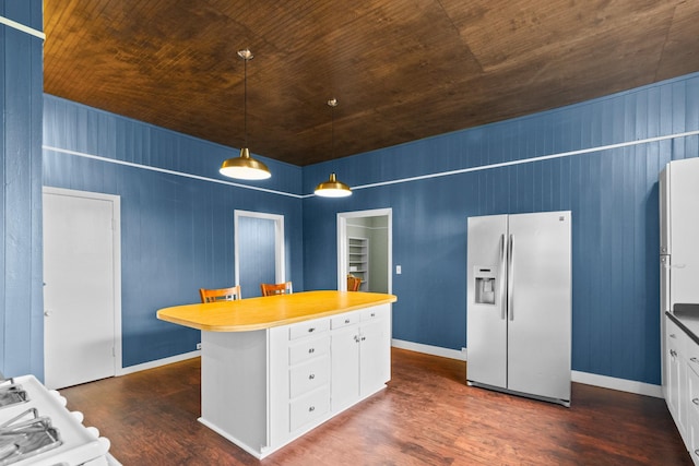 1002 E Gonzales St, Yoakum, TX 77995 - kitchen with refrigerator with ice dispenser, dark wood-style flooring, wooden ceiling, white cabinetry, and a kitchen island