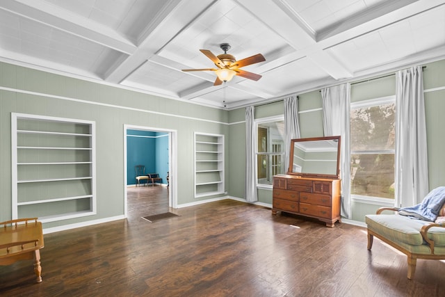 1002 E Gonzales St, Yoakum, TX 77995 - living area featuring built in shelves, coffered ceiling, a ceiling fan, wood finished floors, and beamed ceiling