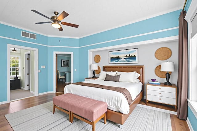 1002 E Gonzales St, Yoakum, TX 77995 - bedroom featuring light wood finished floors, ornamental molding, and ceiling fan