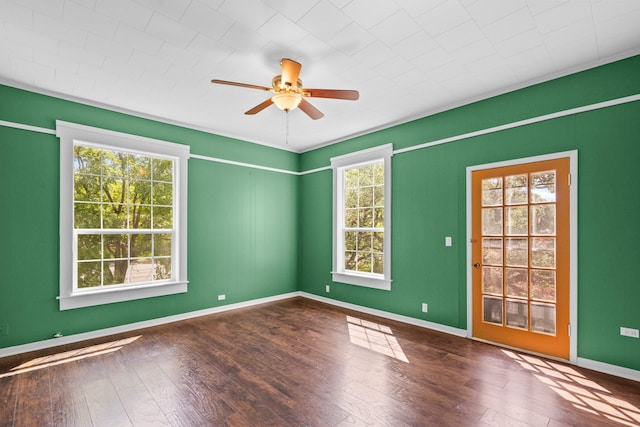 1002 E Gonzales St, Yoakum, TX 77995 - spare room with healthy amount of natural light, ceiling fan, and wood-type flooring